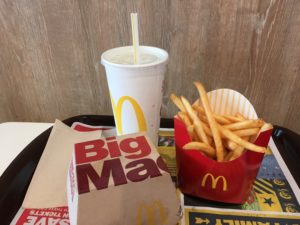 Picture of a meal at McDonald's, showing hamberger, fries and a drink.