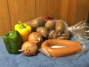 picture of groceries, potatoes, peppers, onions, and sausage