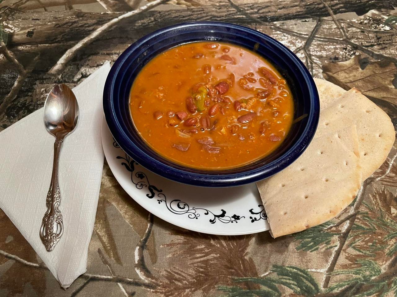 Bowl of chili with pita bread on the side